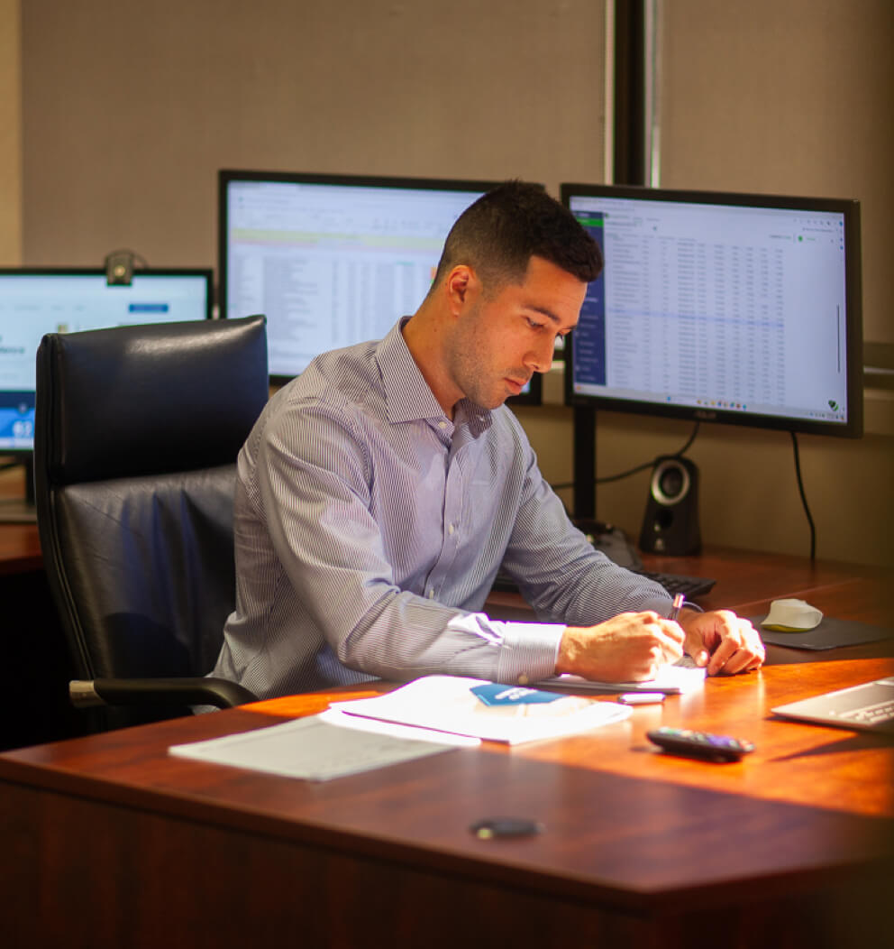 Photo of GVA advisor working at desk.